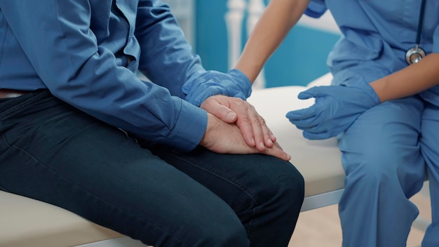 Free photo medical assistant comforting senior patient to help with recovery, showing compassion after finding out health care diagnosis. nurse giving support after sharing disease news. close up.