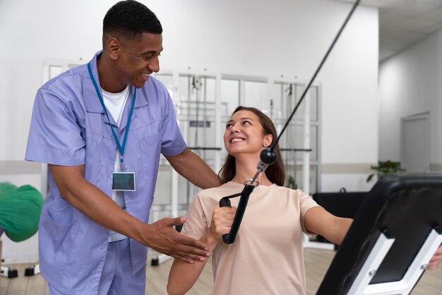 Medical assistant helping patient with physiotherapy exercises