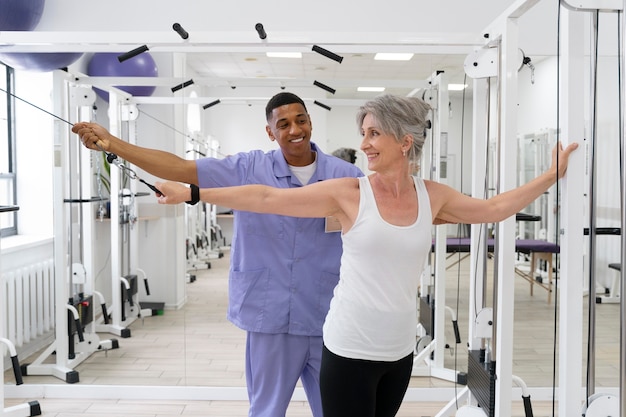 Medical assistant helping patient with physiotherapy exercises