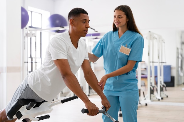 Medical assistant helping patient with physiotherapy exercises