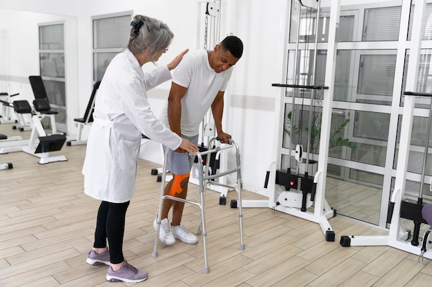 Medical assistant helping patient with physiotherapy exercises