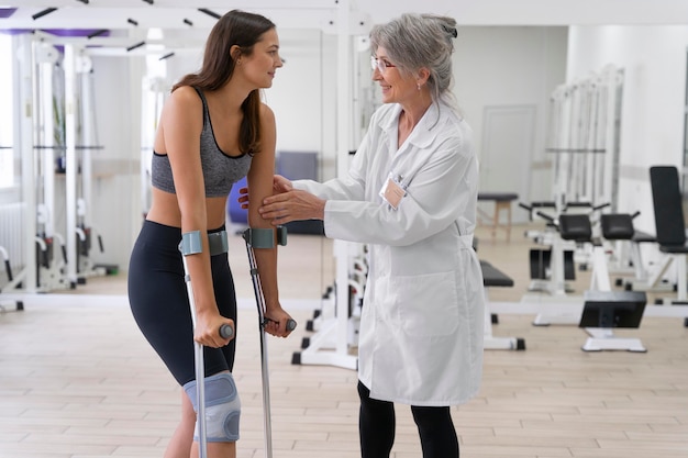 Medical assistant helping patient with physiotherapy exercises