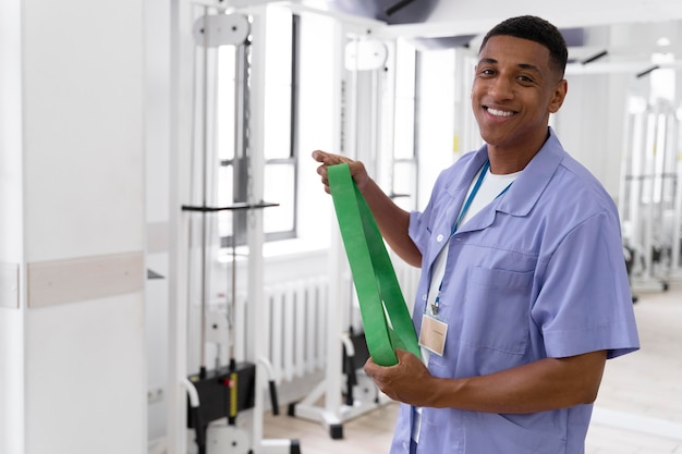 Medical assistant preparing for physiotherapy exercises