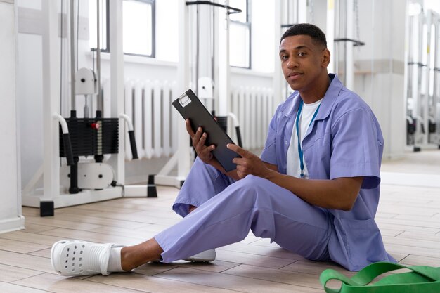 Medical assistant preparing for physiotherapy exercises