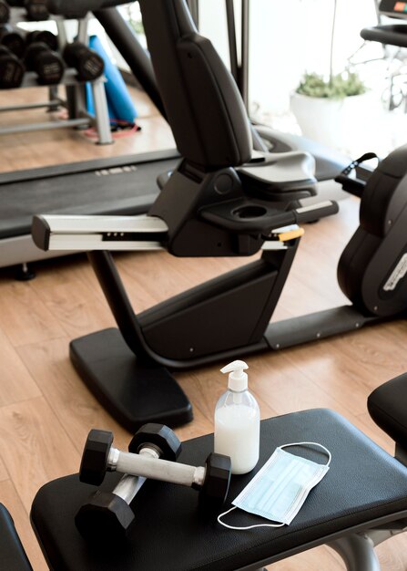 Medical mask on gym equipment with weights