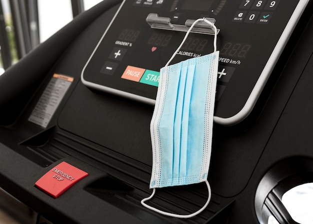 Medical mask hanging on gym equipment