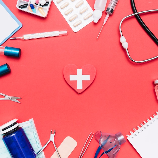 Free photo medical supplies around heart with cross