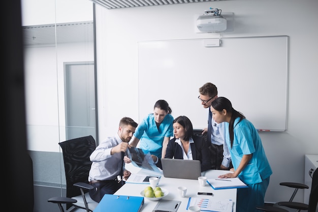 Free Photo medical team examining an x-ray report