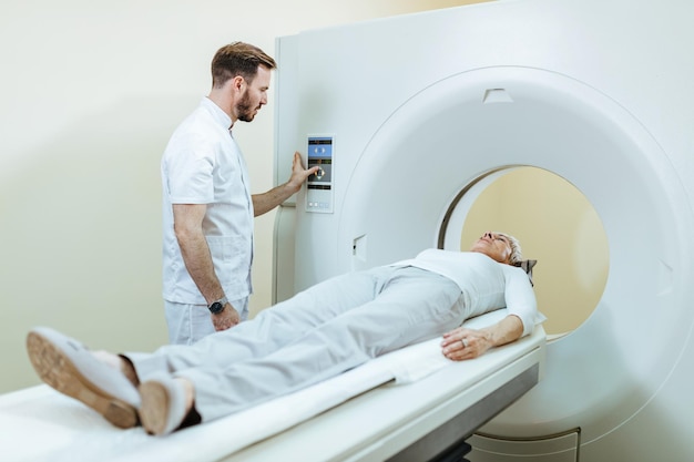 Free photo medical technician and mature patient during mri scanning procedure at clinic