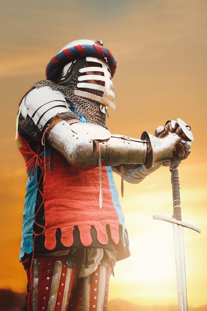 Free Photo medieval knight posing with sword