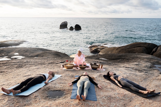 Free photo meditation guide with singing bowls full shot