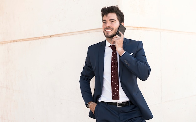 Medium shot adult in suit talking on the phone