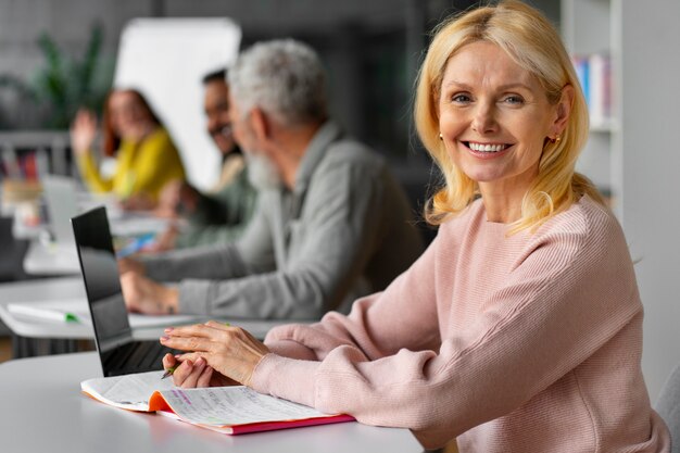 Medium shot adults studying together