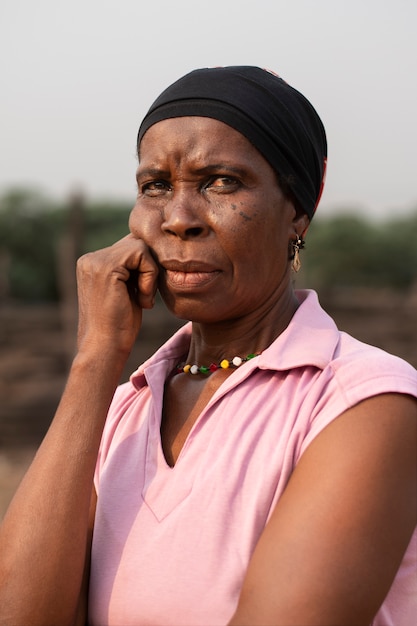 Medium shot african woman outdoors