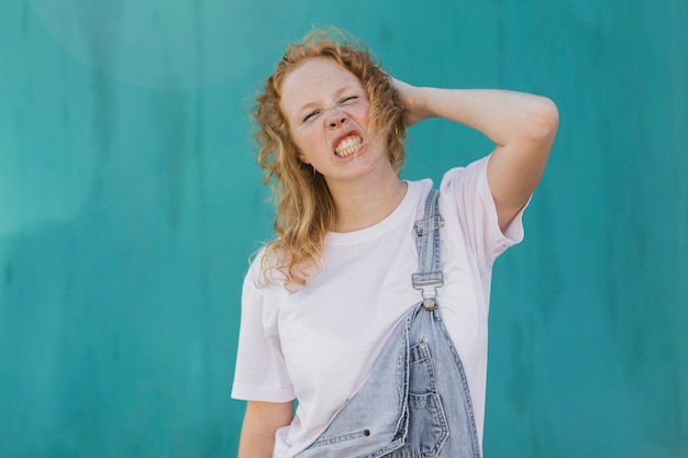 Free Photo medium shot angry girl with blue background