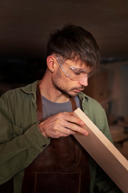 Free photo medium shot artisan doing woodcutting