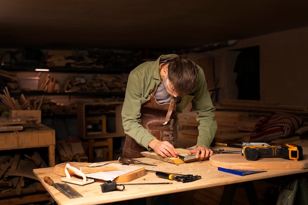 Free Photo medium shot artisan doing woodcutting