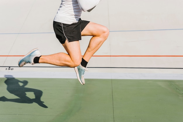 Medium shot of athlete jumping during his training