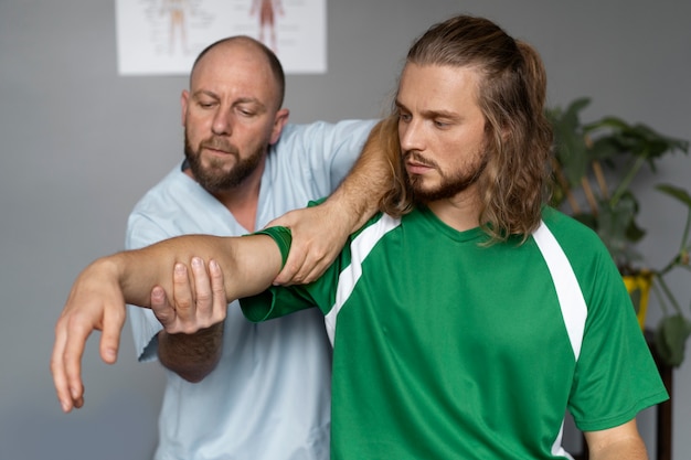 Medium shot athlete at physiotherapy appointment