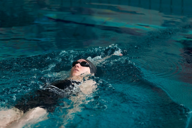 Free photo medium shot athlete swimming with goggles