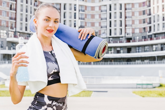 Free Photo medium shot of athlete with mat and towel