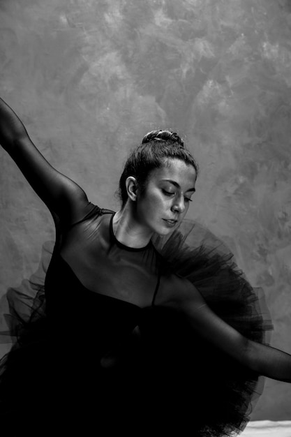 Free photo medium shot ballerina bending grayscale