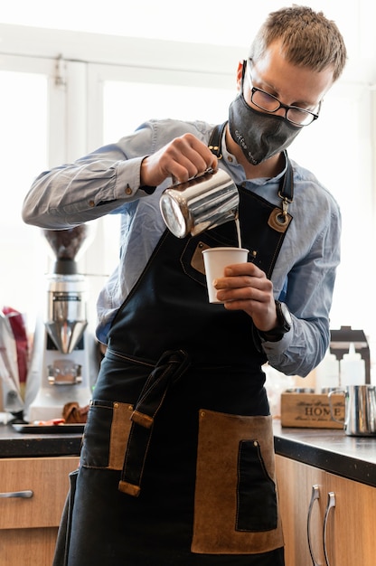 Medium shot barista wearing face mask