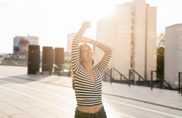 Medium shot beautiful smiley woman posing on sunlight