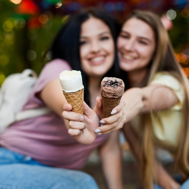 Medium shot best friends posing with ice cream