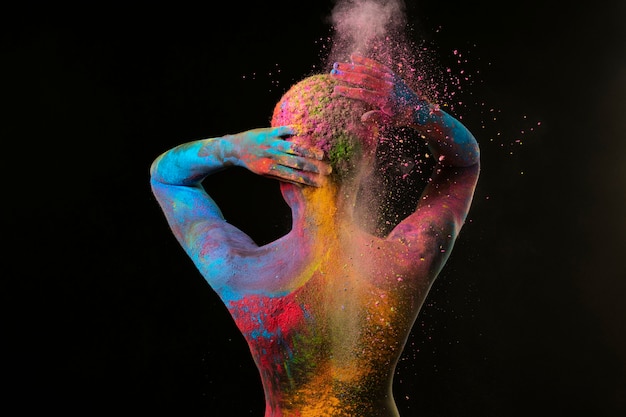 Free photo medium shot black woman posing with colorful powder