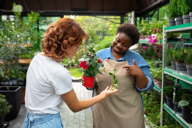 Medium shot black woman running a flower business