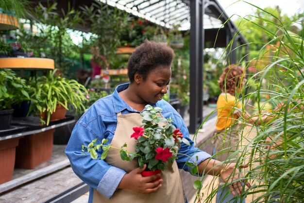 Medium shot black woman running a flower business