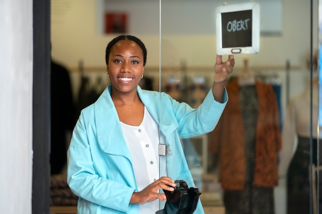 Free Photo medium shot black woman running a small business