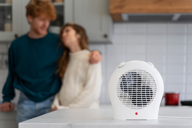 Medium shot blurry couple with heater