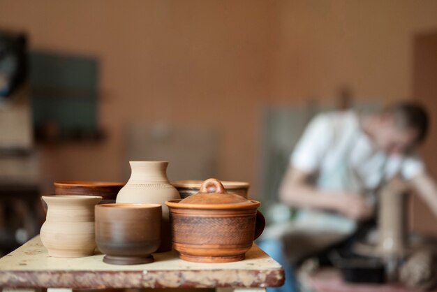 Medium shot blurry man doing pottery