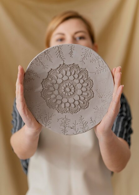 Medium shot blurry woman holding plate