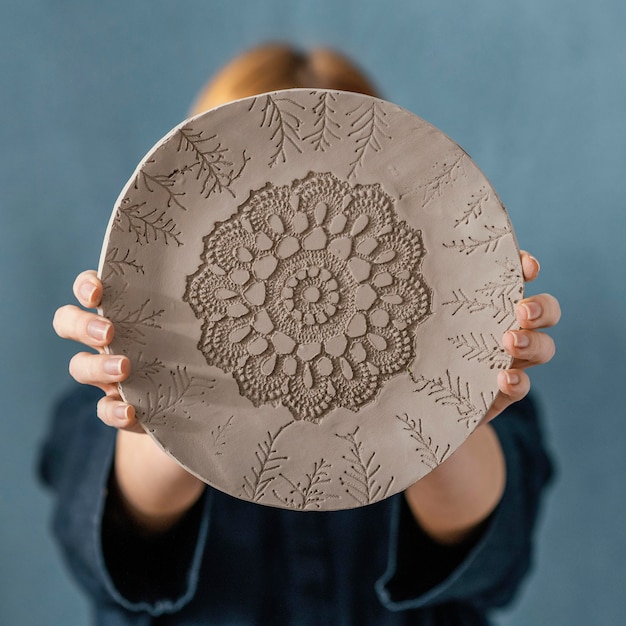 Free photo medium shot blurry woman holding plate