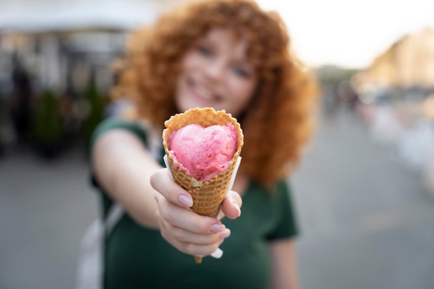 Medium shot blurry woman with ice cream