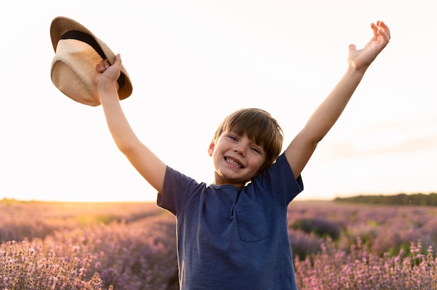 Free photo medium shot boy holding hat