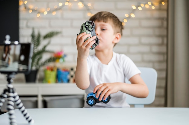 Medium shot boy playing with cars