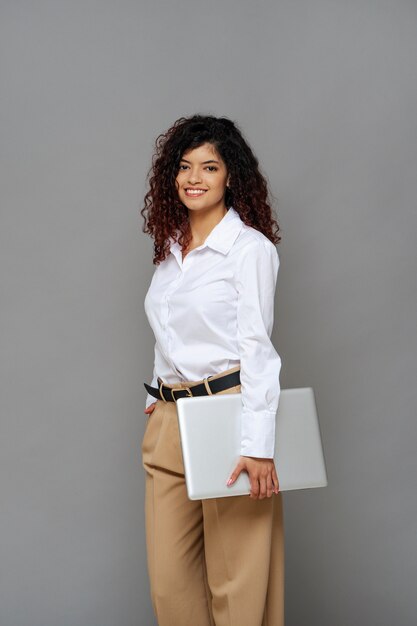 Medium shot business woman holding laptop