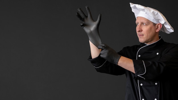 Free photo medium shot chef wearing gloves