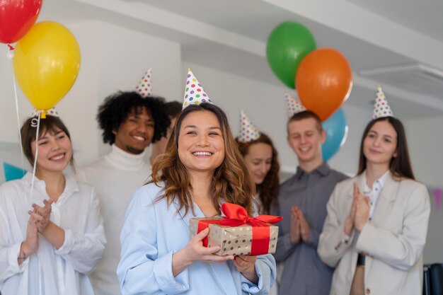 Medium shot colleagues celebrating birthday at work