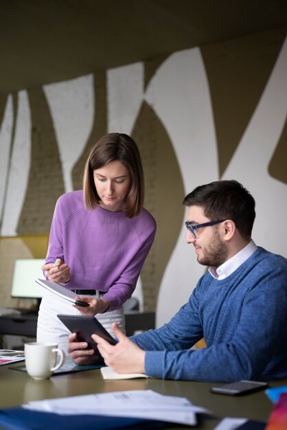 Medium shot colleagues debating ideas at office