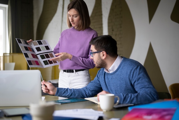 Medium shot colleagues picking colors