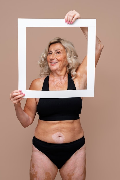 Free photo medium shot confident old woman posing in underwear