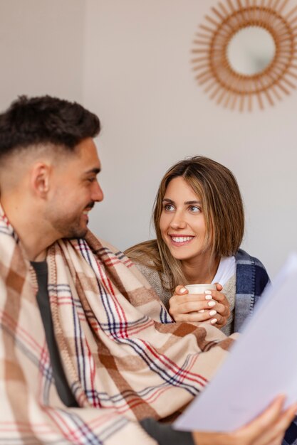 Medium shot couple being affectionate indoors