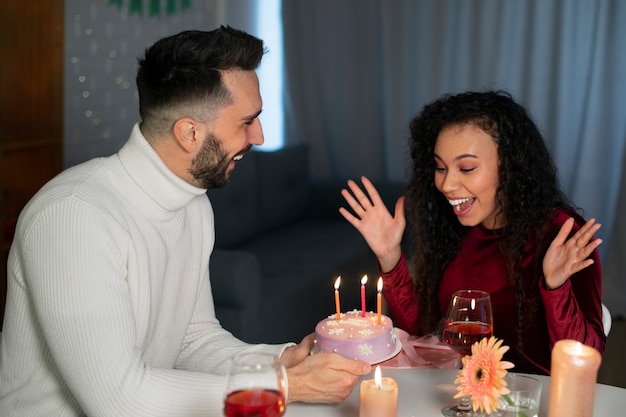 Medium shot couple celebrating birthday