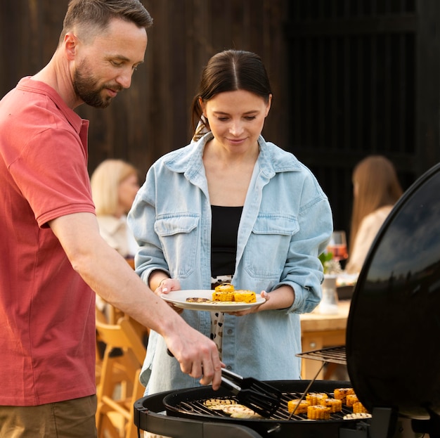 Free photo medium shot couple cooking together