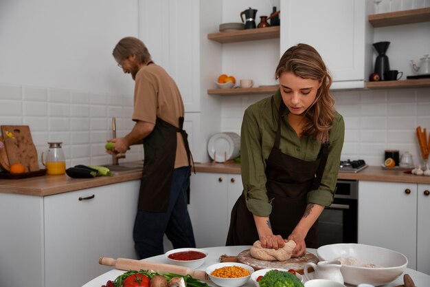 Medium shot couple cooking together